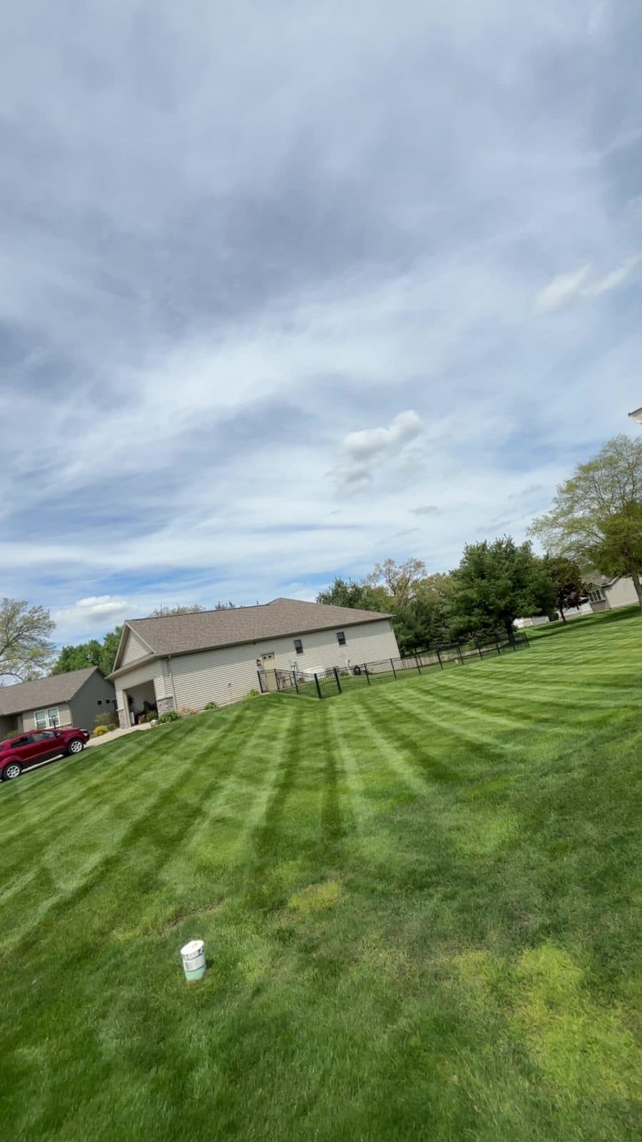 A residential lawn freshly mowed with clean, straight mowing stripes by Fresh Cut Lawns.