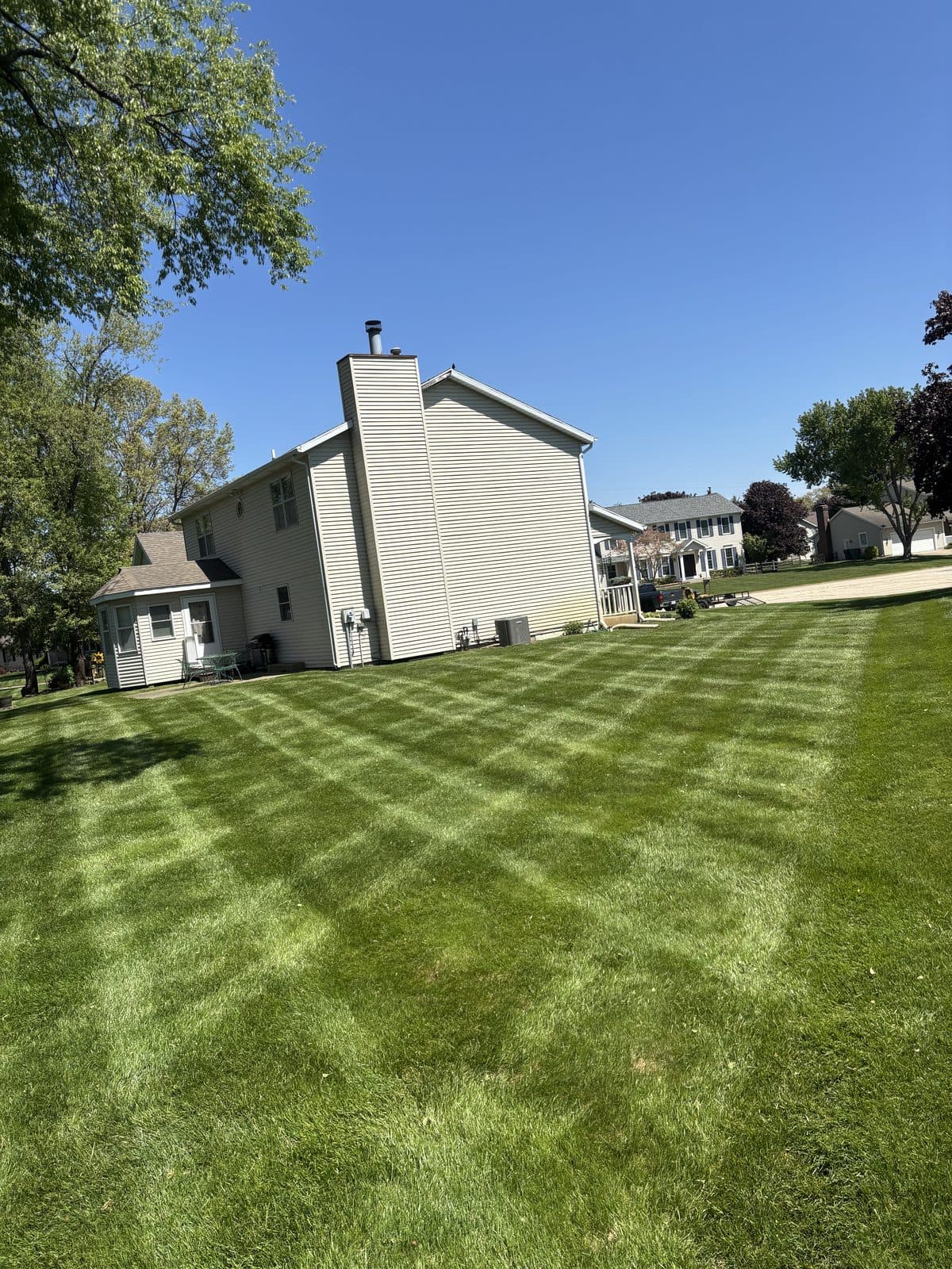 A residential lawn freshly mowed with clean, straight mowing stripes by Fresh Cut Lawns.